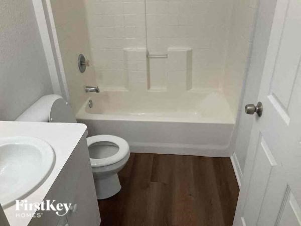 a bathroom with a toilet and a tub and a sink