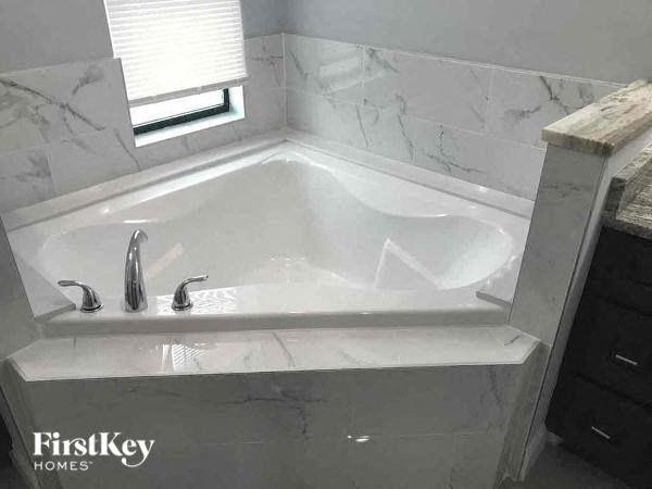a bath tub in a bathroom with a window