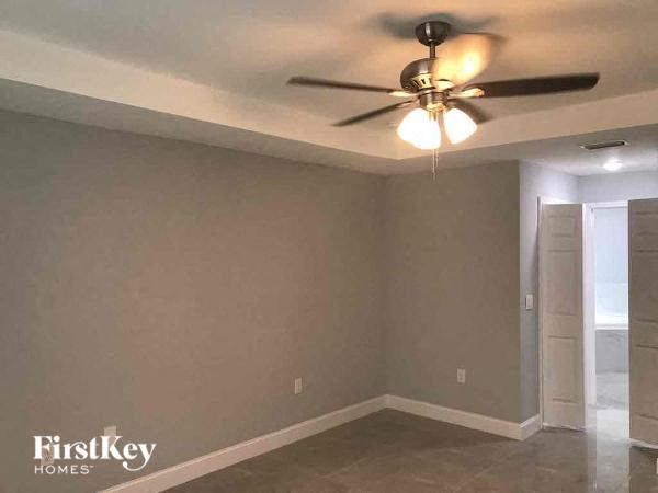 an empty room with a ceiling fan