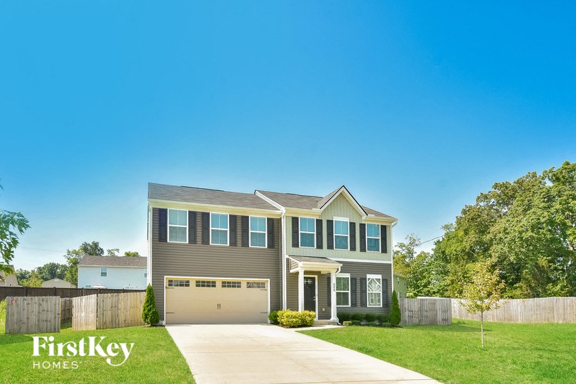 a house with a garage door and a lawn