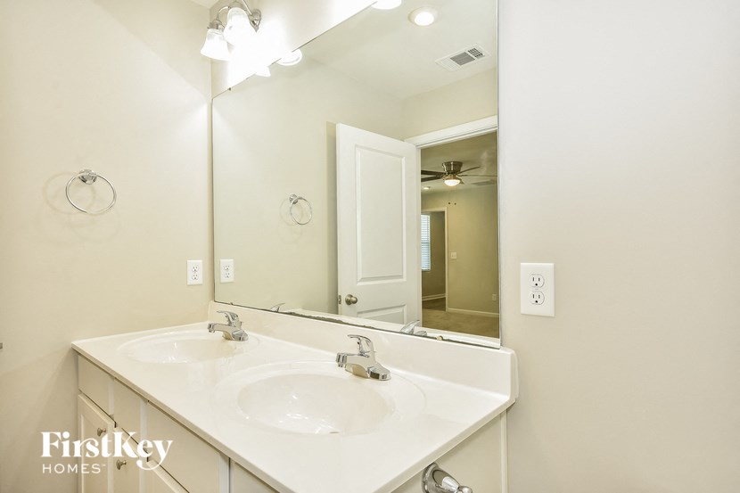 a bathroom with two sinks and a large mirror