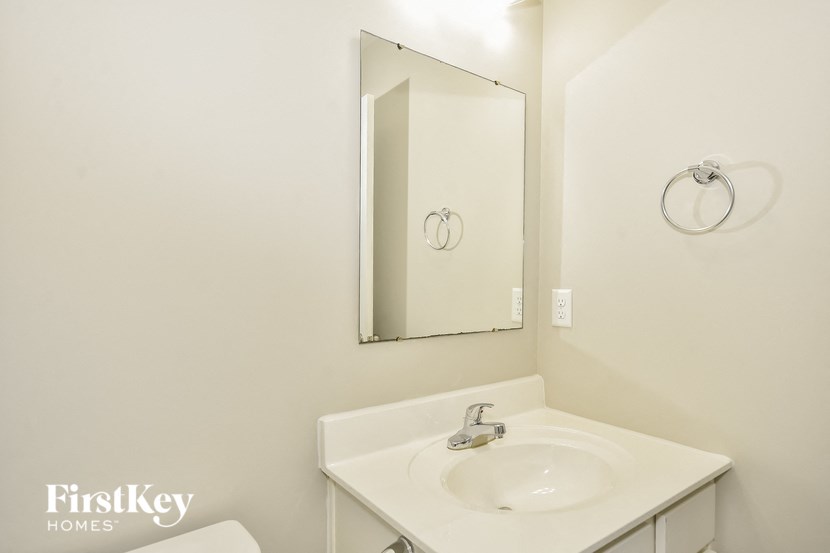 a white bathroom with a sink and a mirror