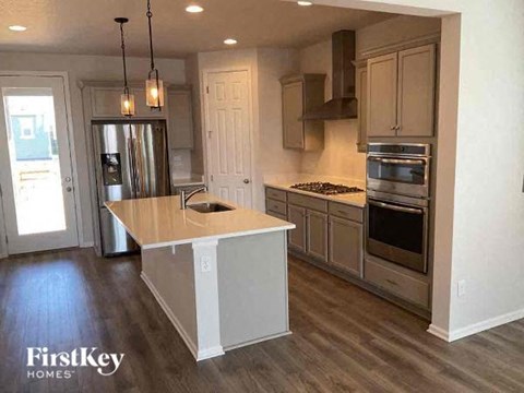 a kitchen with an island and stainless steel appliances