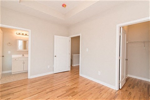 a empty living room with a door open to a bathroom