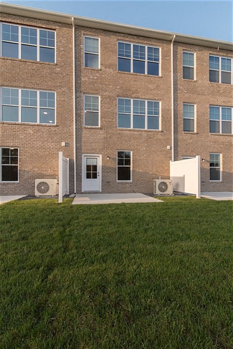 a brick building with green grass in front of it
