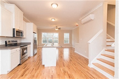 an empty kitchen with a stove and a sink