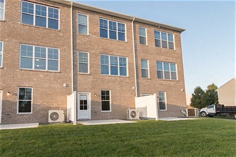 a brick building with a lawn in front of it