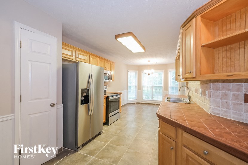 a kitchen with wooden cabinets and stainless steel appliances