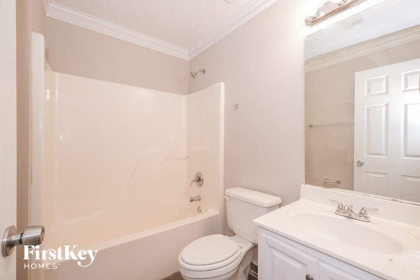 a bathroom with a sink toilet and a tub