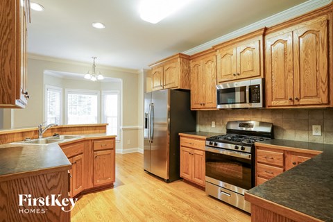 A kitchen with wooden cabinets and stainless steel appliances.