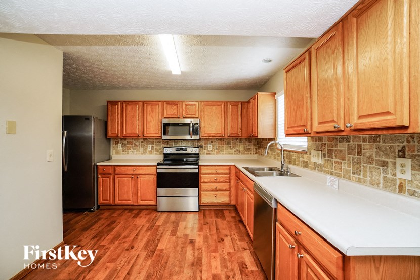 a kitchen with wooden cabinets and a white counter top