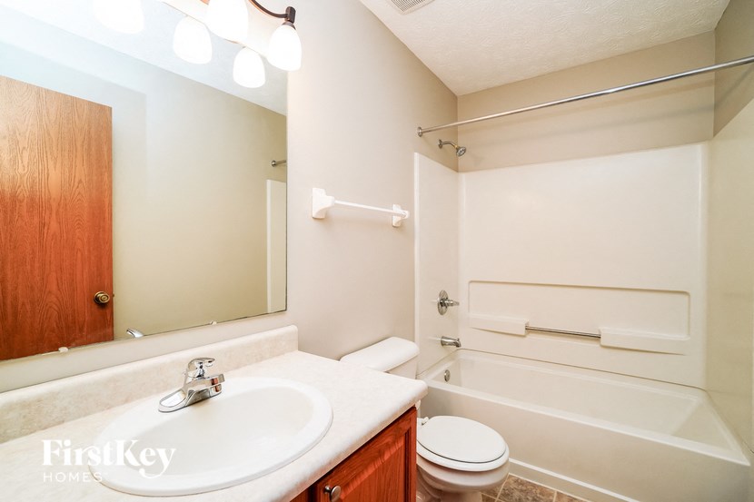 a bathroom with a sink and a toilet and a bath tub