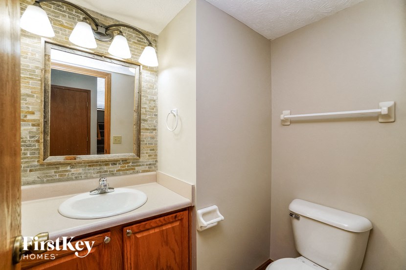 a bathroom with a toilet and a sink and a mirror