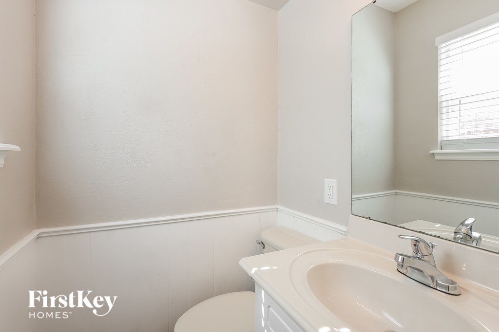 a bathroom with a sink and a toilet and a mirror