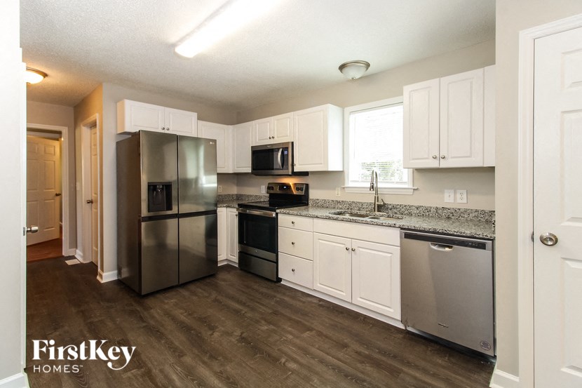 a kitchen with stainless steel appliances and white cabinets