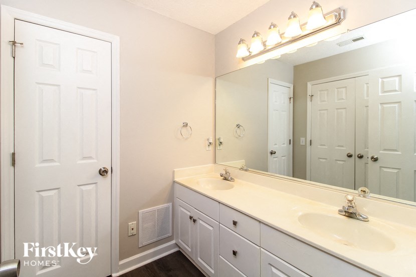 a bathroom with two sinks and a large mirror