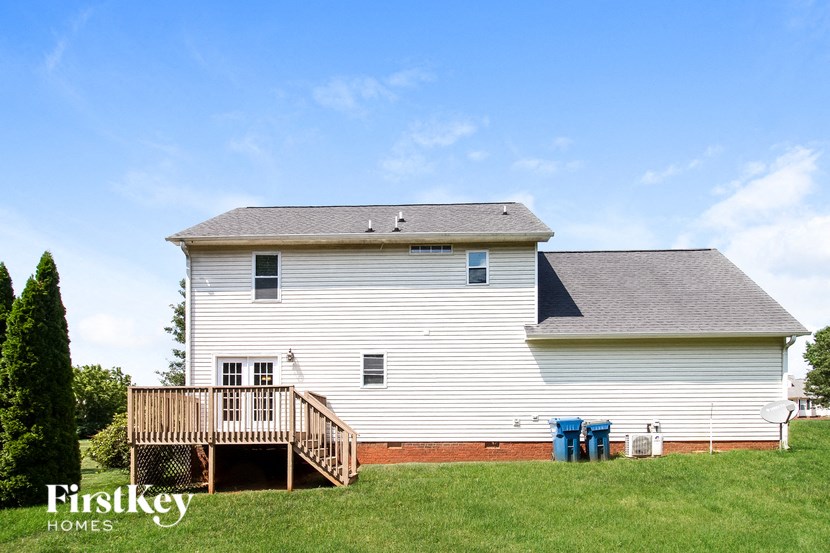 a white house with a porch and a deck