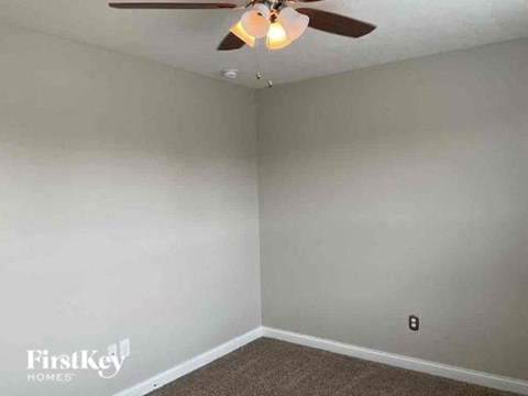 an empty room with a ceiling fan and