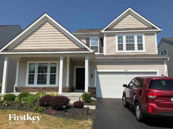 a house with a red car parked in front of it