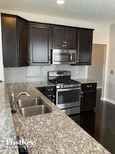 a kitchen with stainless steel appliances and granite counter tops