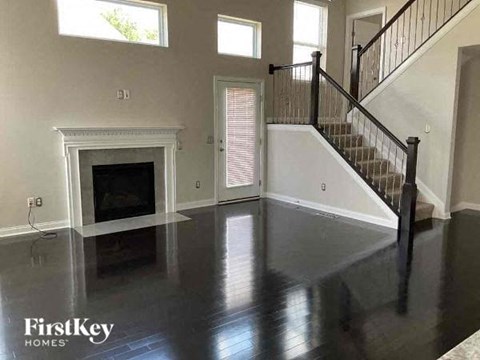 a living room with a fireplace and a staircase