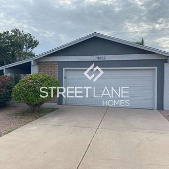 a streetlane homes sign on the side of a garage door