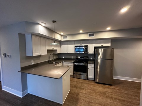 a kitchen with stainless steel appliances and white cabinets