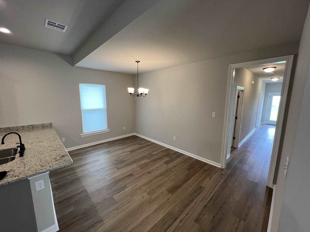 a dining room and living room with hard wood floors and a window