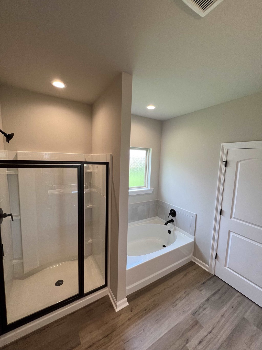 a large white bathroom with a tub and a shower