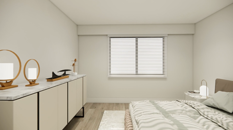 A bedroom with a bed, nightstand, and a window with blinds.