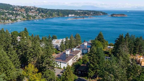 a view of the house and the lake from above