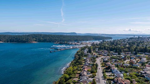 A coastal town with a body of water and a clear sky.