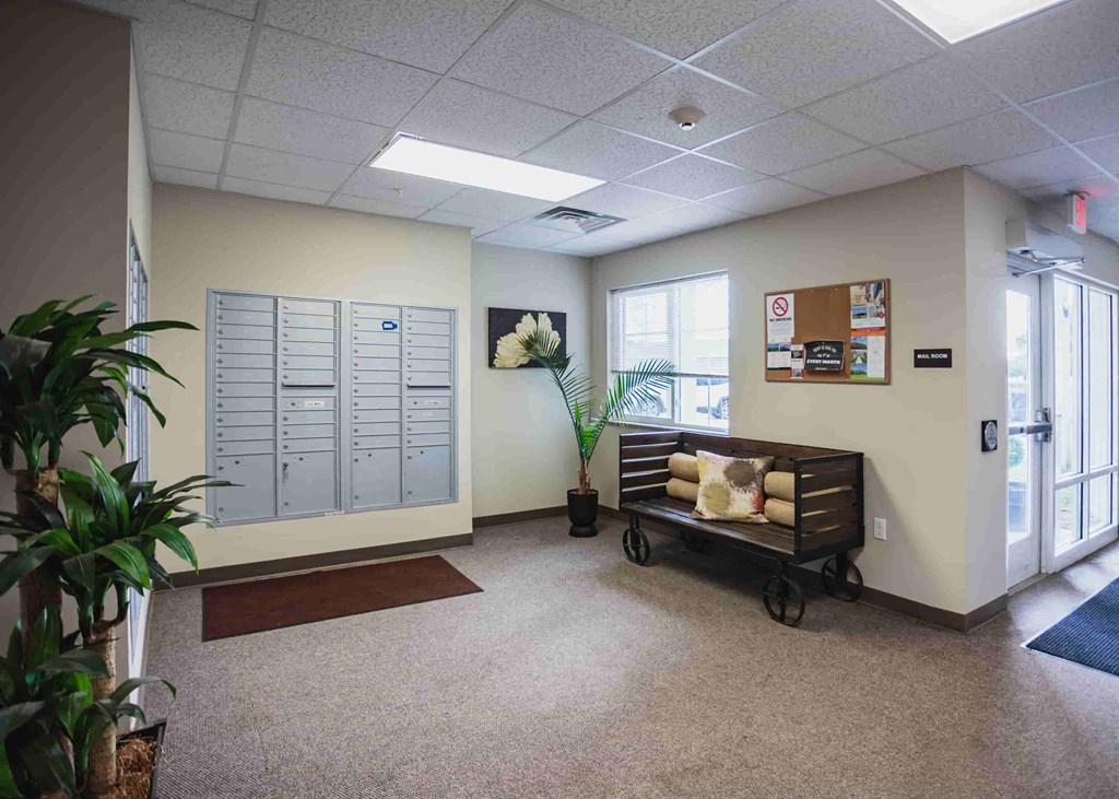 a hallway with a bench and lockers in a building