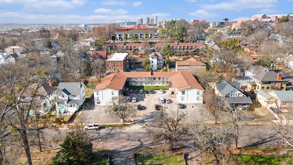 an aerial view of a neighborhood with houses and a city in the background