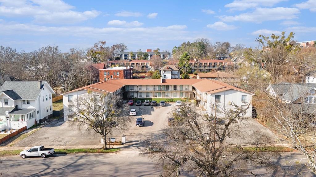 an aerial view of a building with a parking lot