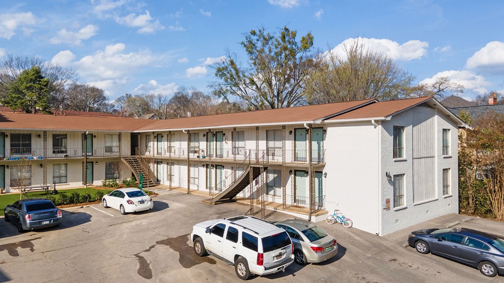 an apartment building with cars parked in front of it
