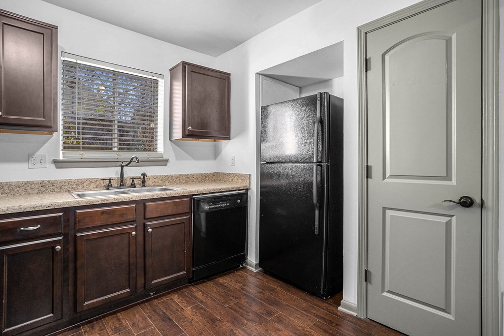 a kitchen with a sink and a refrigerator