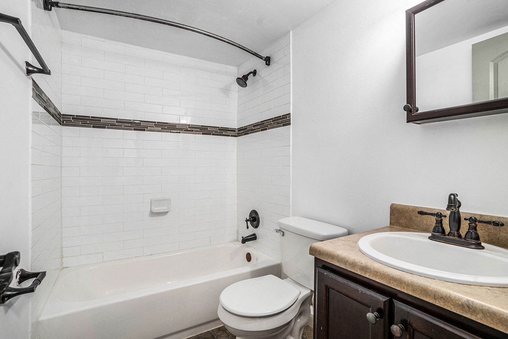 a bathroom with a sink toilet and a tub