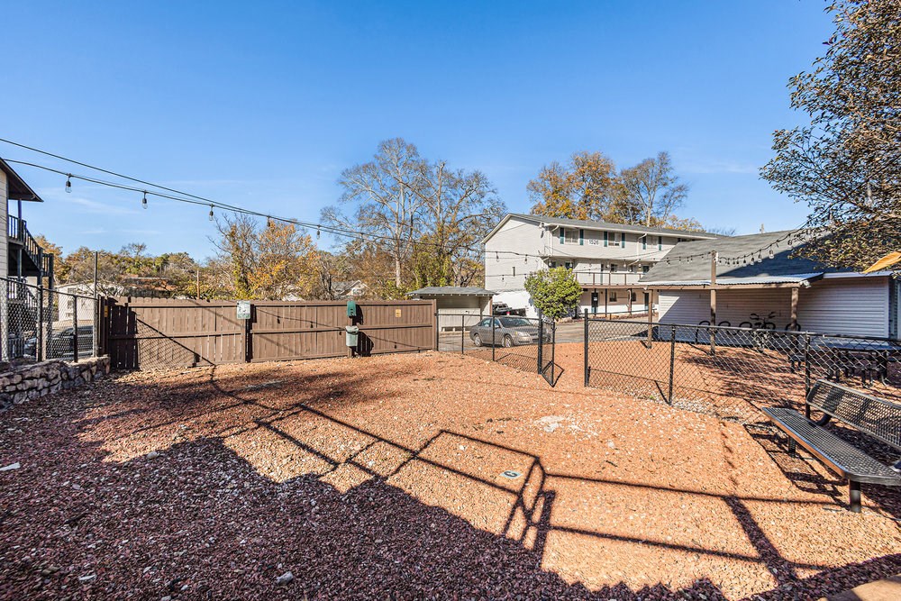 a fenced in yard with a house in the background