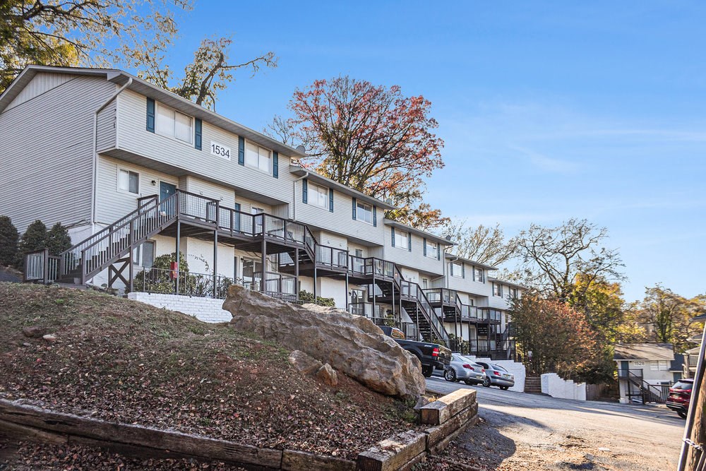 the exterior of a building with stairs and a parking lot