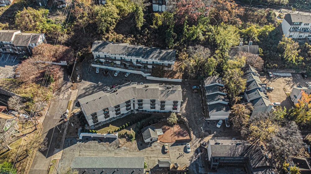 an aerial view of a building surrounded by trees