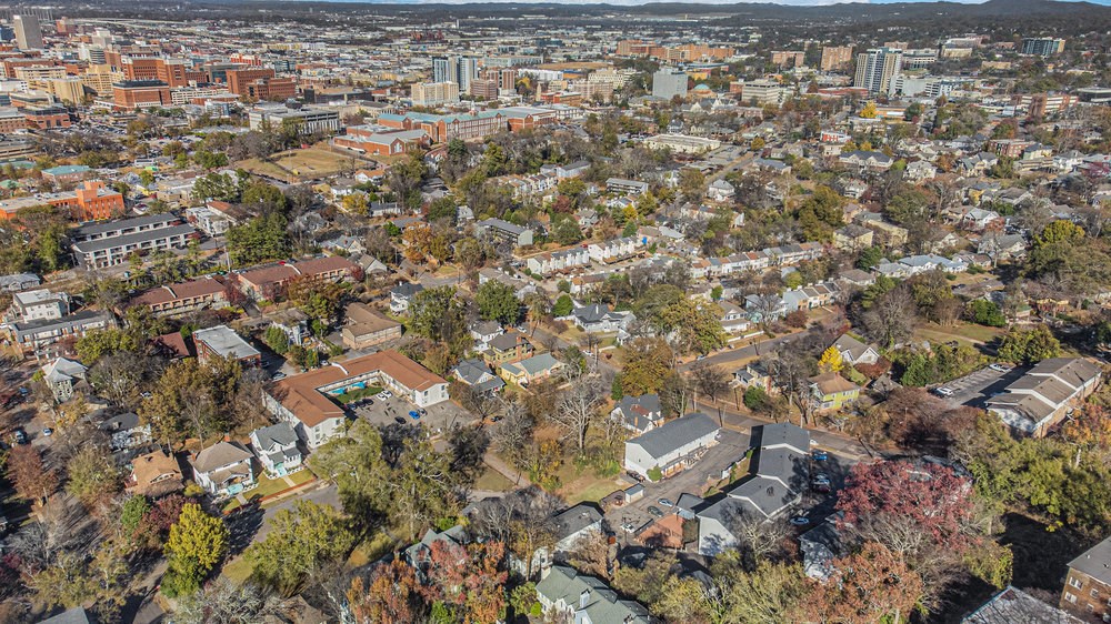 an aerial view of a city with buildings and trees