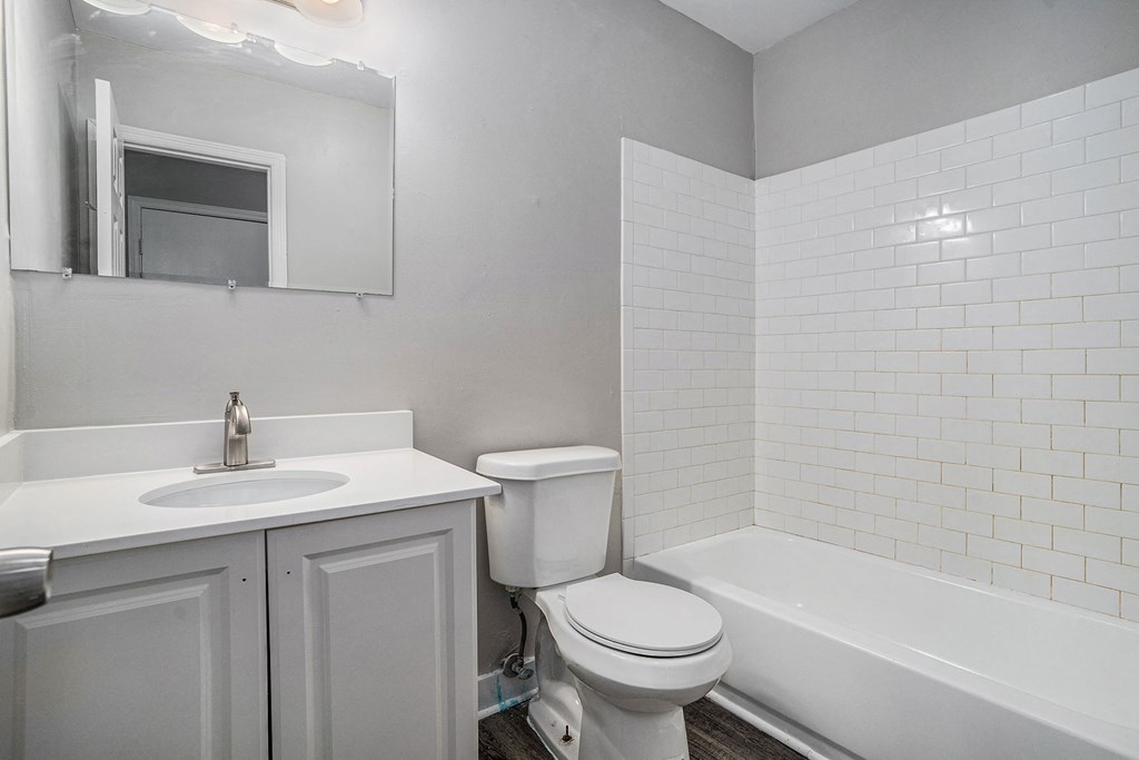 an empty bathroom with a sink toilet and bath tub