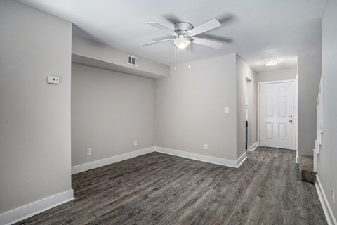 the living room of a new home with a ceiling fan