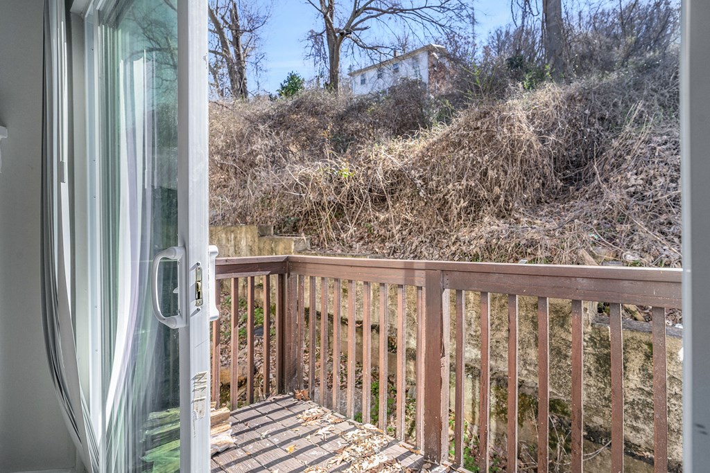 a balcony with a view of a house on a hill