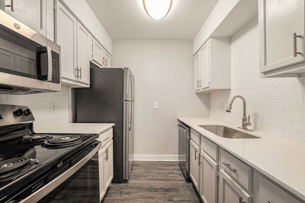 a kitchen with stainless steel appliances and white cabinets