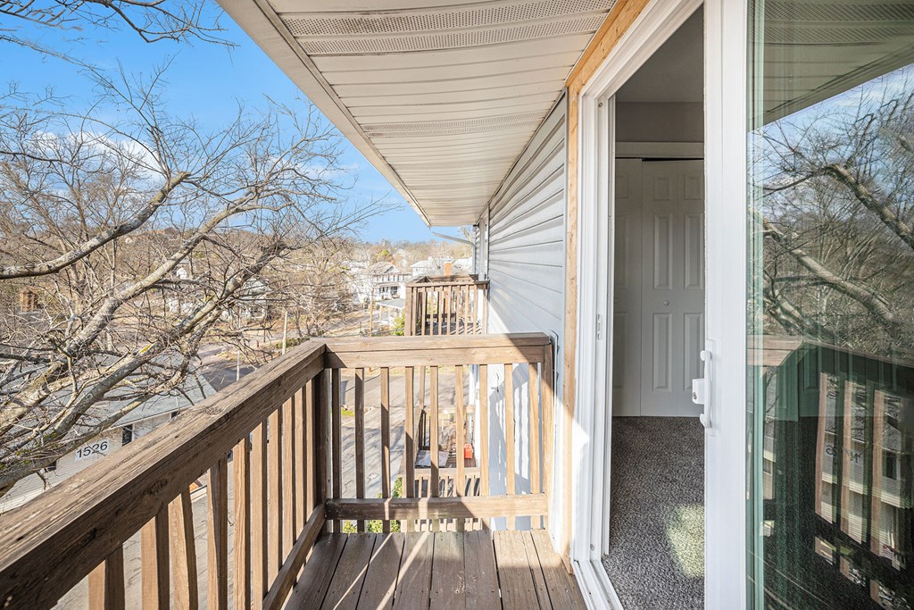 the view from the deck of a home with a wooden railing
