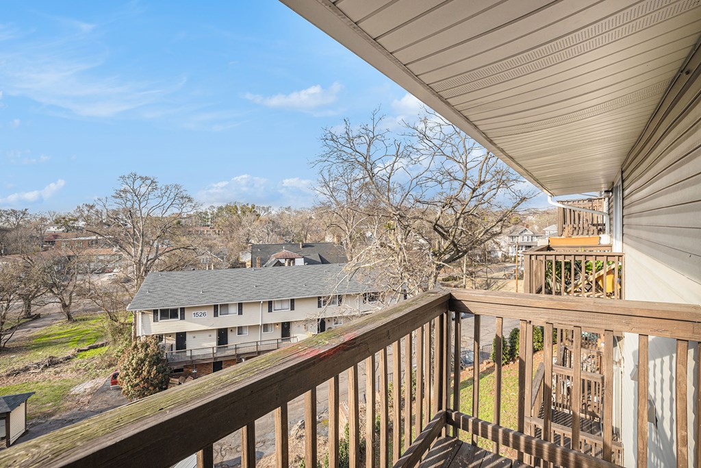 the view from the deck of a house overlooking other houses and trees
