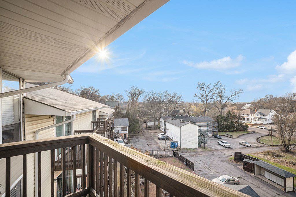 the view from the deck of a home with a yard and buildings