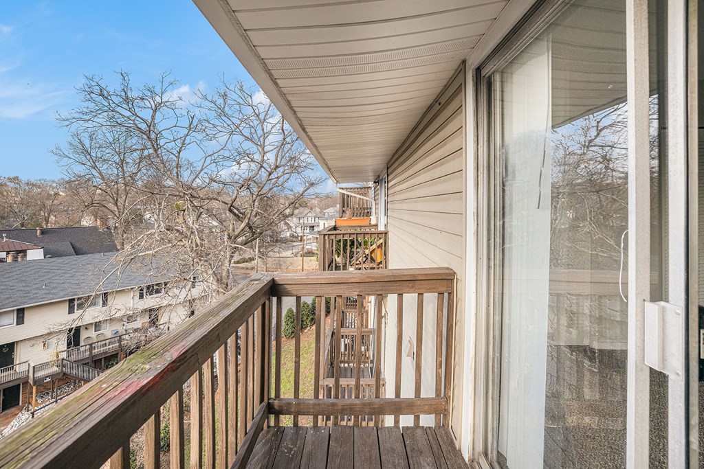 the balcony has a view of the neighborhood and the city